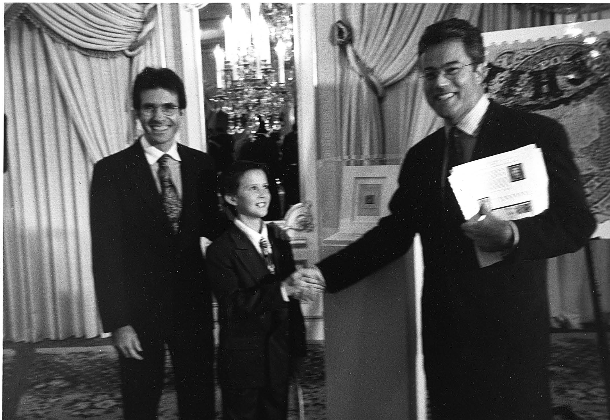 Scott Trepel congratulating Sundmans on the purchase of the 1c Z Grill — Siegel Auction Galleries